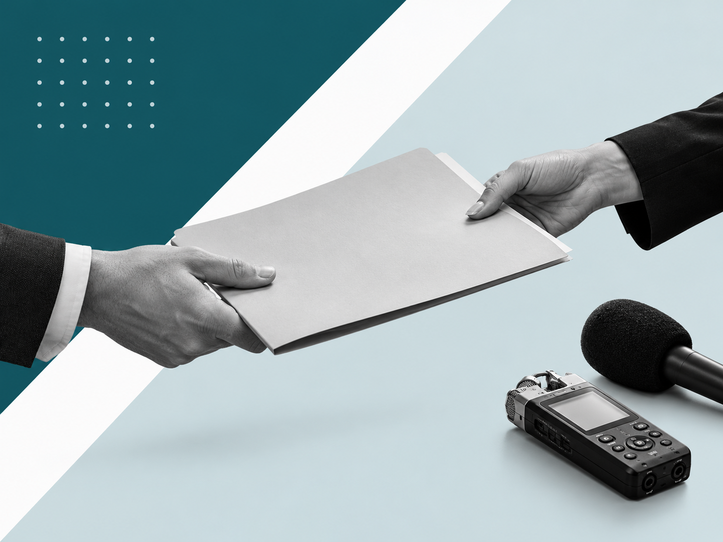 Hands exchanging a press document beside a microphone and audio recorder.